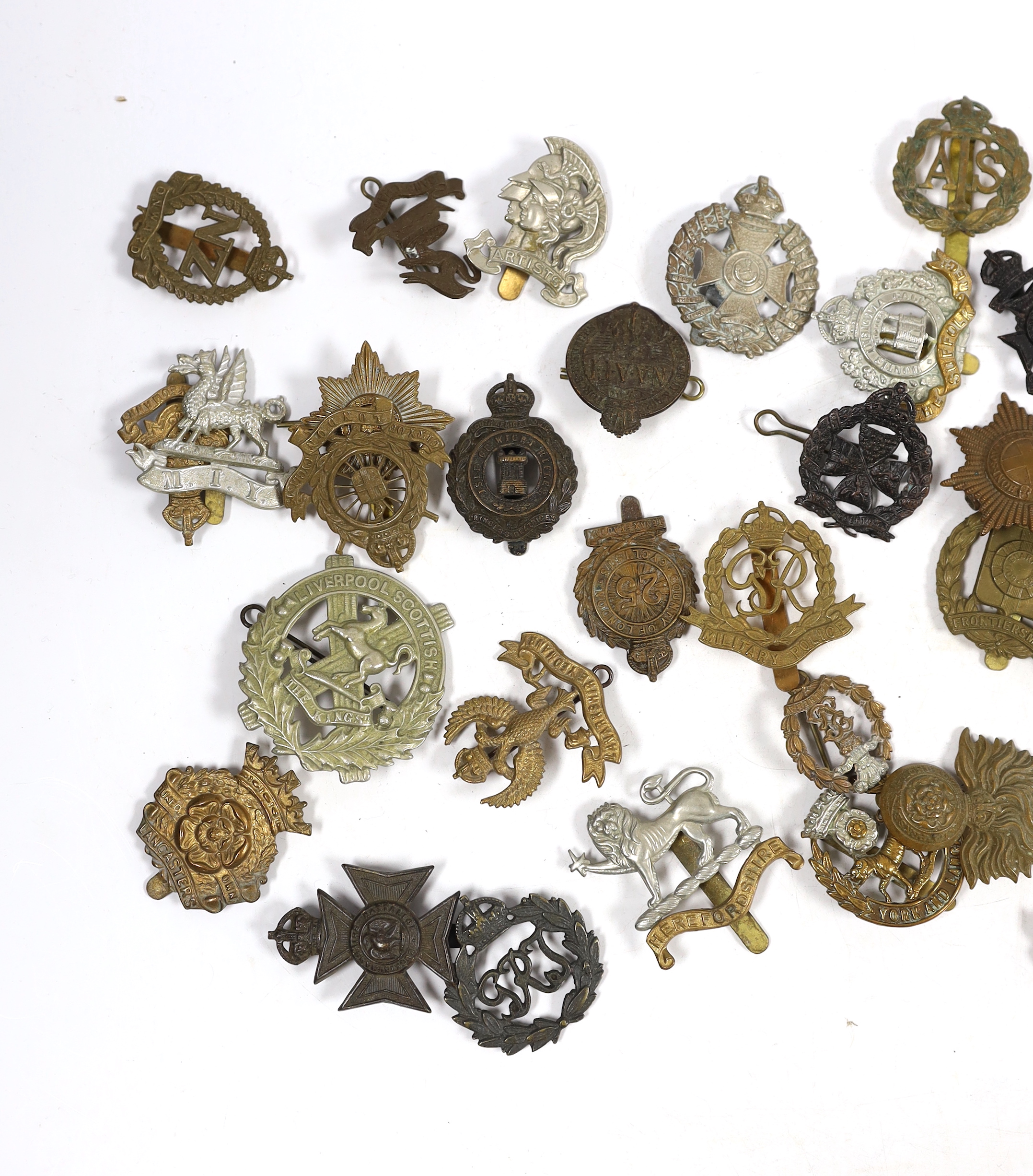 Forty military cap badges including City of London Cyclists, Lincolnshire Yeomanry, Connaught Rangers, The County of London, Royal Gloucestershire Hussars, NAAFI, Military Police, the Rangers, Sussex Yeomanry, Lanarkshir